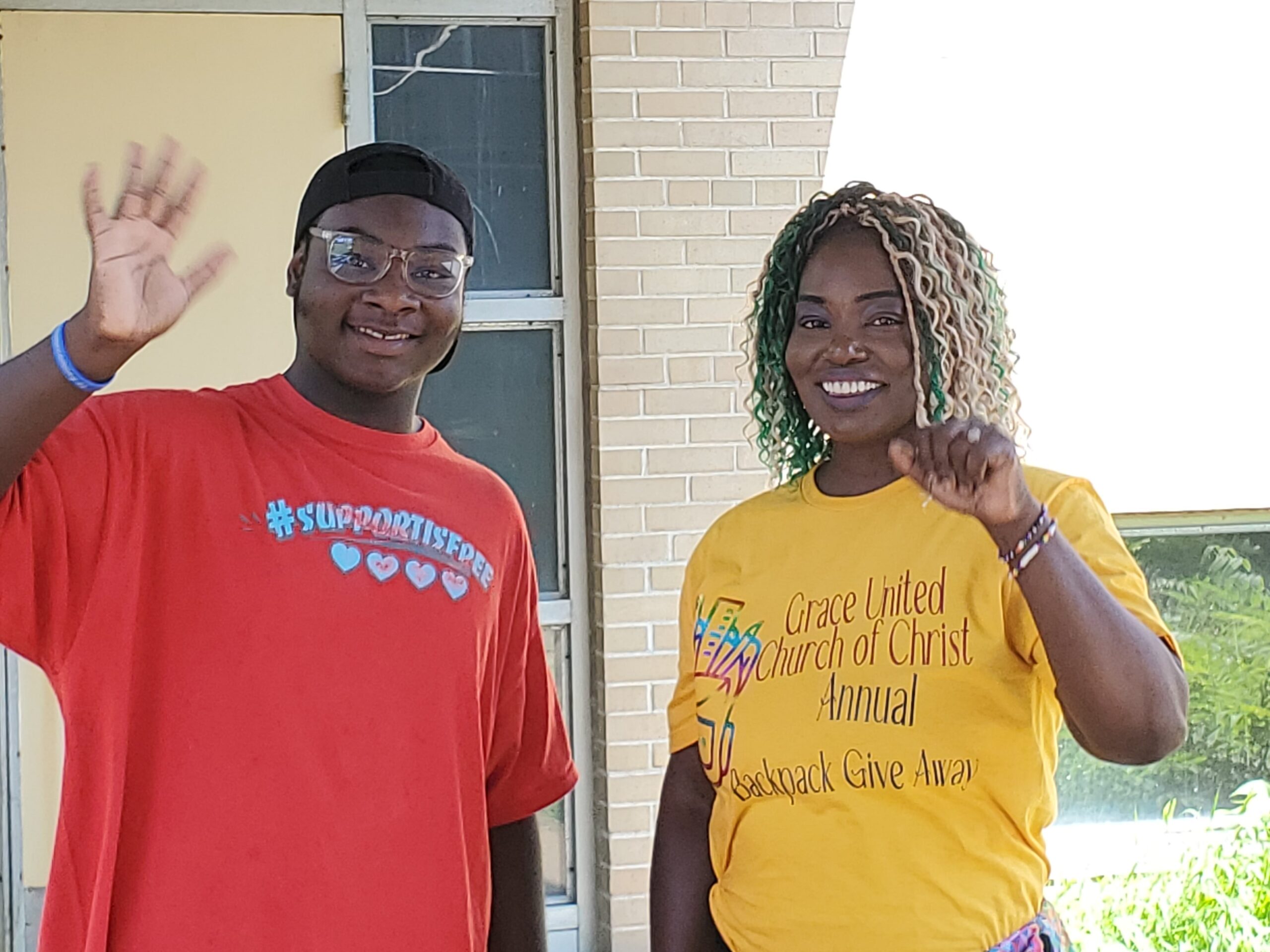 Two Grace UCC Members smiling during annual backpack give away