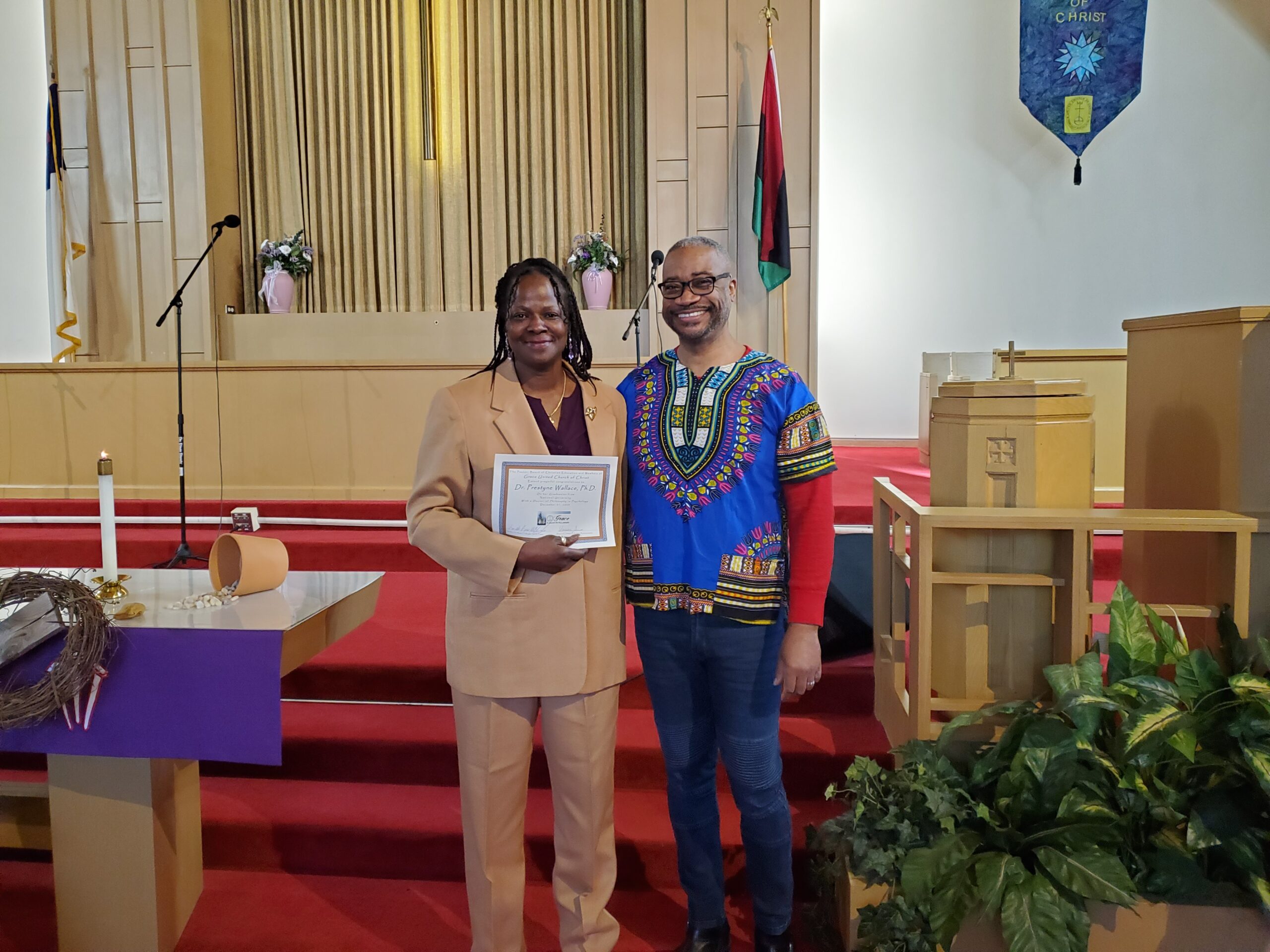 Rev. Reno D Wright standing next to a new member